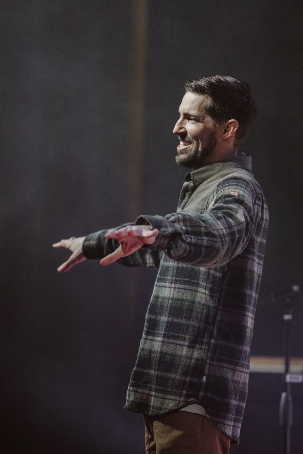 Parker Manuel teaching, smiling with his arms stretched out